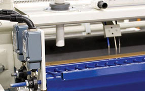 Evans Midwest countertop laminating system applying adhesive to core and laminate sheet
